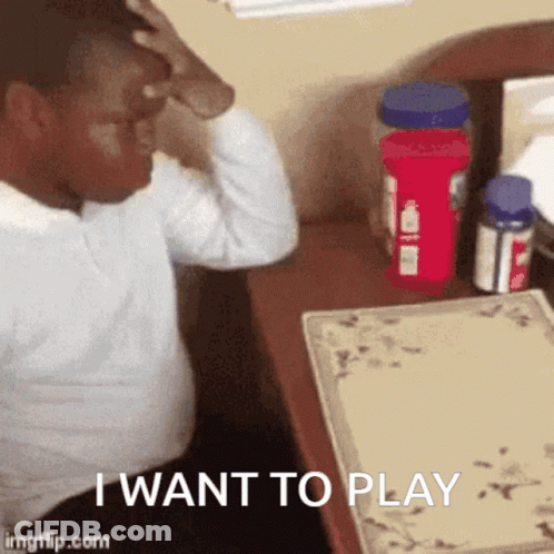 Man Sitting At Desk Hand On Head Saying I Want To Play GIF