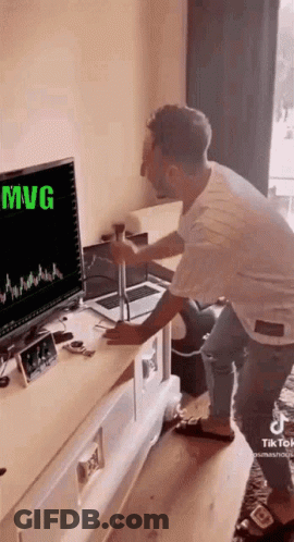 Man Sitting At Desk In Front Of Computer GIF