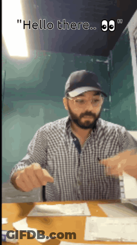 Man Sitting At Desk Saying Hello There GIF
