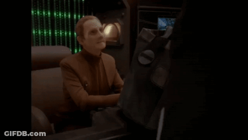 Man Sitting At Desk Saying Ohh Let Me See GIF