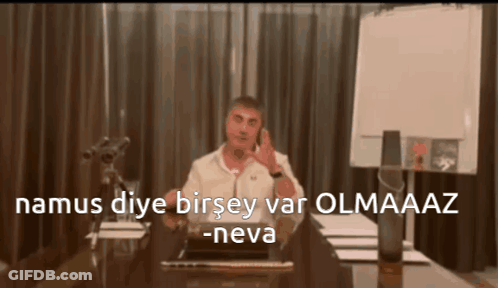 Man Sitting At Desk Talking On Cell Phone Namus Diye Birsey Var Olmaaz -Neva GIF