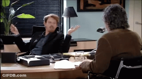 Man Sitting At Desk Talking To Another GIF