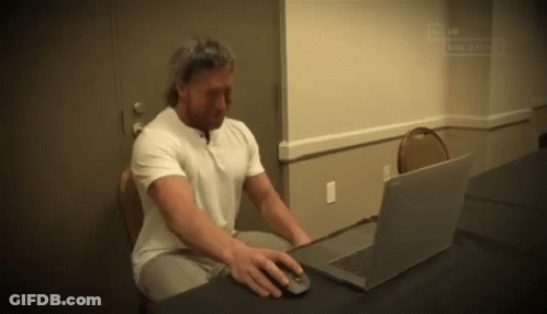 Man Sitting At Desk Using Laptop GIF