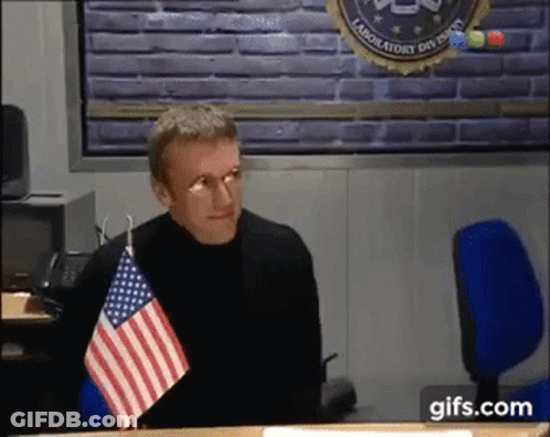 Man Sitting At Desk With American Flag GIF