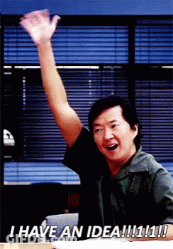 Man Sitting At Desk With Arm In Air GIF
