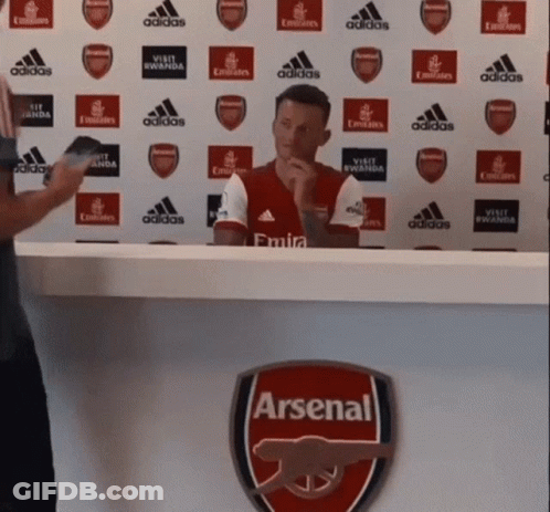 Man Sitting At Desk With Arsenal Logo GIF