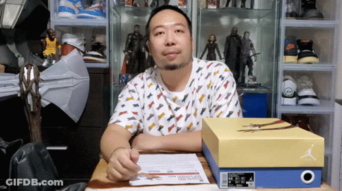 Man Sitting At Desk With Box Of Air Jordans GIF