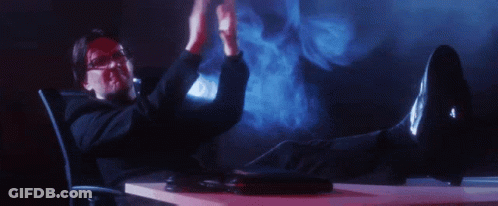 Man Sitting At Desk With Feet And Hands Up GIF