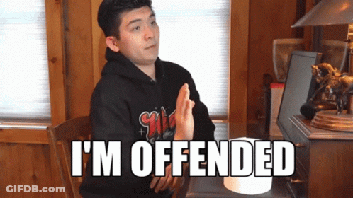 Man Sitting At Desk With I'm Offended On Screen GIF
