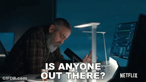 Man Sitting At Desk With Netflix Logo GIF