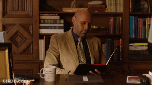 Man Sitting At Desk With Okay To Be Different Mug GIF