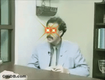 Man Sitting At Desk With Red Eyes And Mustache GIF