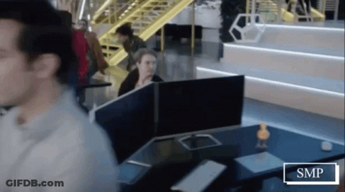 Man Sitting At Desk With SMP Sign GIF