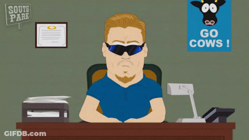 Man Sitting At Desk With South Park Sign GIF