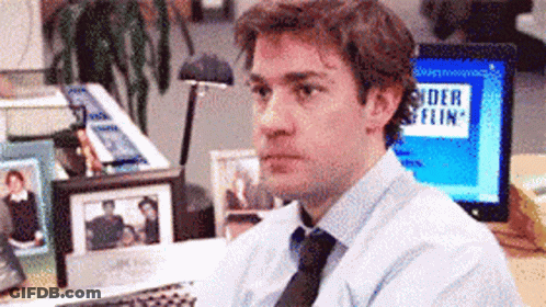 Man Sitting At Desk With Spider Flin Screen GIF
