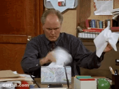 Man Sitting At Desk With Tissues GIF