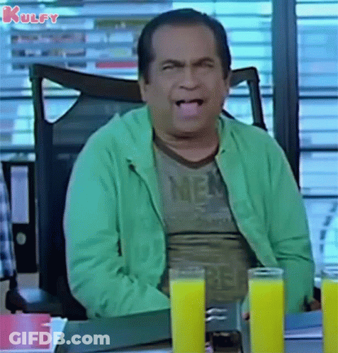 Man Sitting At Desk With Two Glasses Of Orange Juice GIF