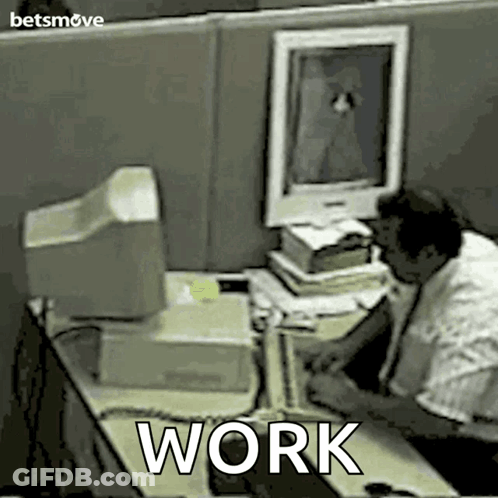 Man Sitting At Desk With Work GIF