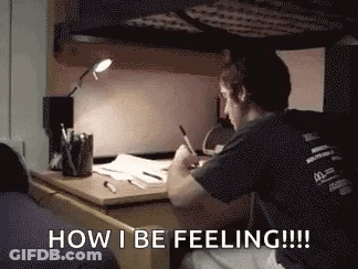 Man Sitting At Desk Writing In Dorm Room GIF
