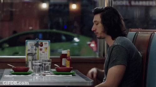 Man Sitting At Diner Table With Menu GIF