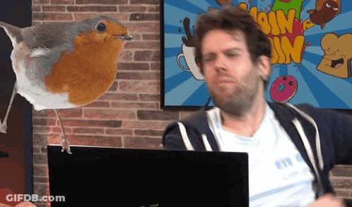 Man Sitting At Laptop With Ssim Cartoon Behind GIF