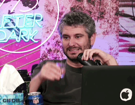 Man Sitting At Microphone In Front Of Chester Dark Sign GIF