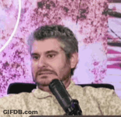 Man Sitting At Microphone Making Funny Face GIF