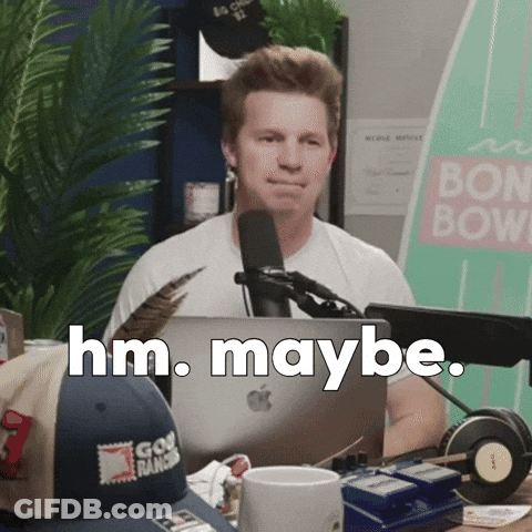 Man Sitting At Microphone Saying Hm Maybe GIF