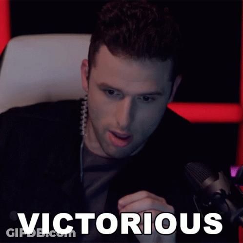 Man Sitting At Microphone Victorious GIF