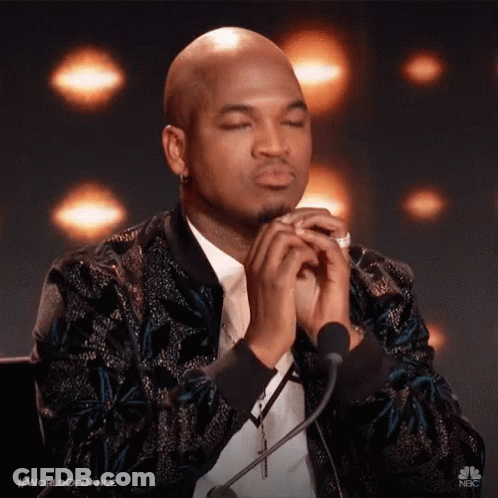 Man Sitting At Microphone With Eyes Closed Praying GIF