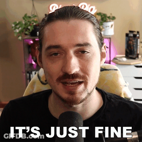 Man Sitting At Microphone With It's Just Fine Behind Him GIF
