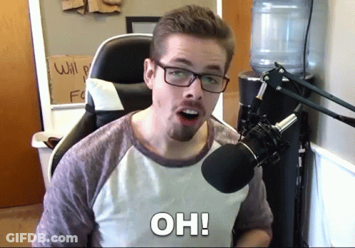 Man Sitting At Microphone With Oh On Chest GIF