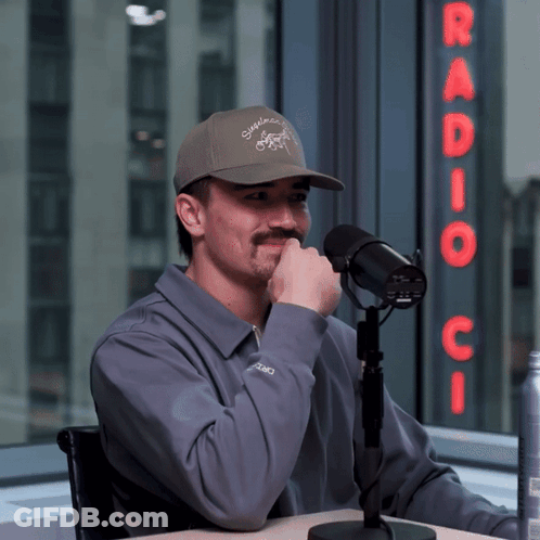 Man Sitting At Microphone With Radio C Sign GIF