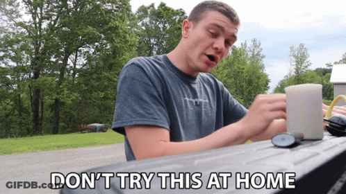 Man Sitting At Table Don't Try This At Home GIF