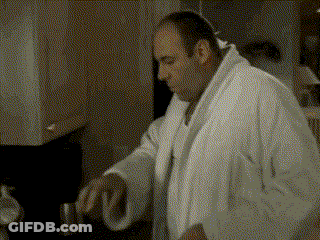 Man Sitting At Table Drinking From Cup GIF