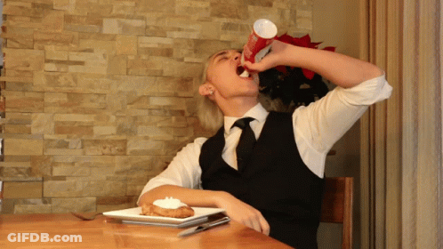 Man Sitting At Table Drinking From Cup GIF