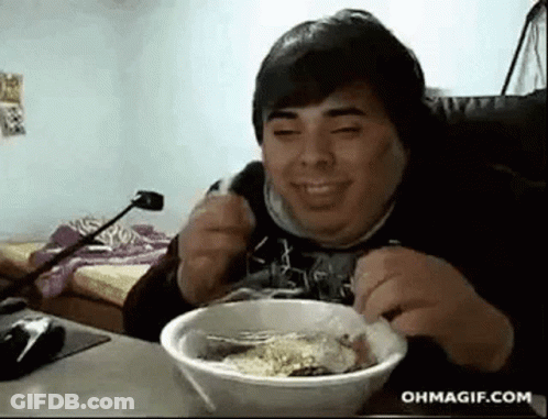 Man Sitting At Table Eating Bowl Of Food Smiling GIF