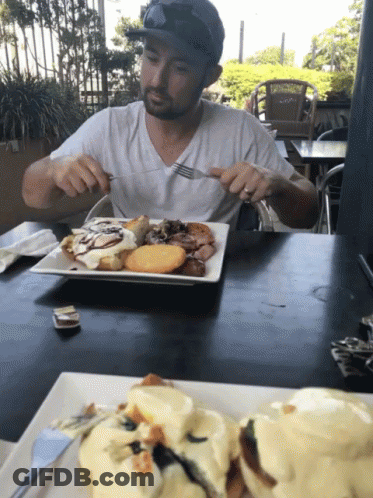 Man Sitting At Table Eating Food GIF