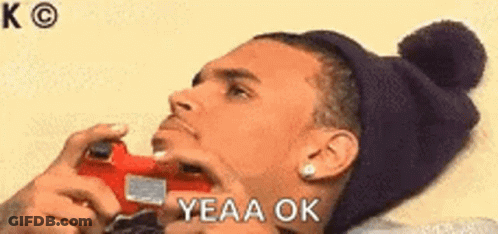 Man Sitting At Table Hand On Chin Saying Yeah Okay GIF