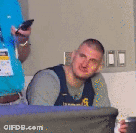 Man Sitting At Table Holding Phone And Beer GIF