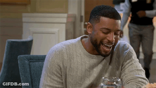 Man Sitting At Table Laughing With Water And Food GIF