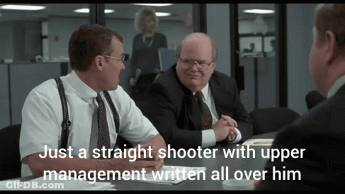 Man Sitting At Table Saying Just A Straight Shooter With Upper Management Written All Over Him GIF