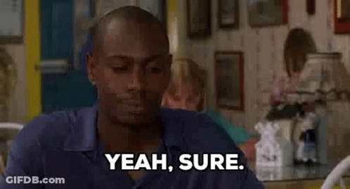 Man Sitting At Table Saying Yeah Sure GIF