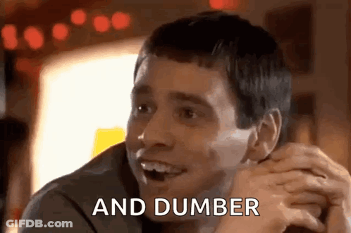 Man Sitting At Table Smiling Hands Folded GIF