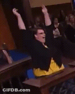 Man Sitting At Table With Arms Up GIF