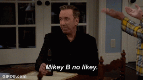 Man Sitting At Table With Beer Saying Mikey B No Likey GIF