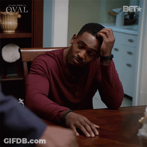 Man Sitting At Table With Bet Logo GIF
