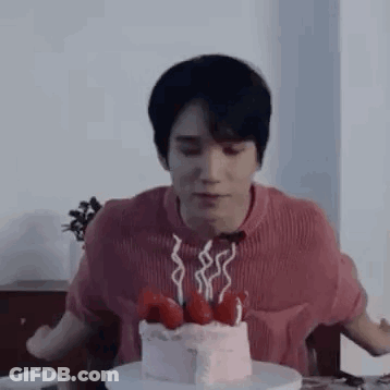 Man Sitting At Table With Cake And Candles GIF