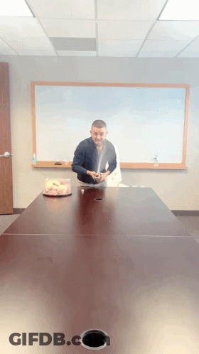 Man Sitting At Table With Cake GIF