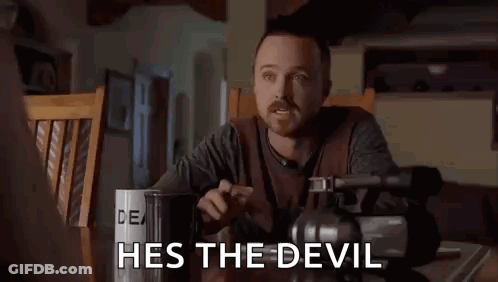 Man Sitting At Table With Camera And Coffee Says He's The Devil GIF